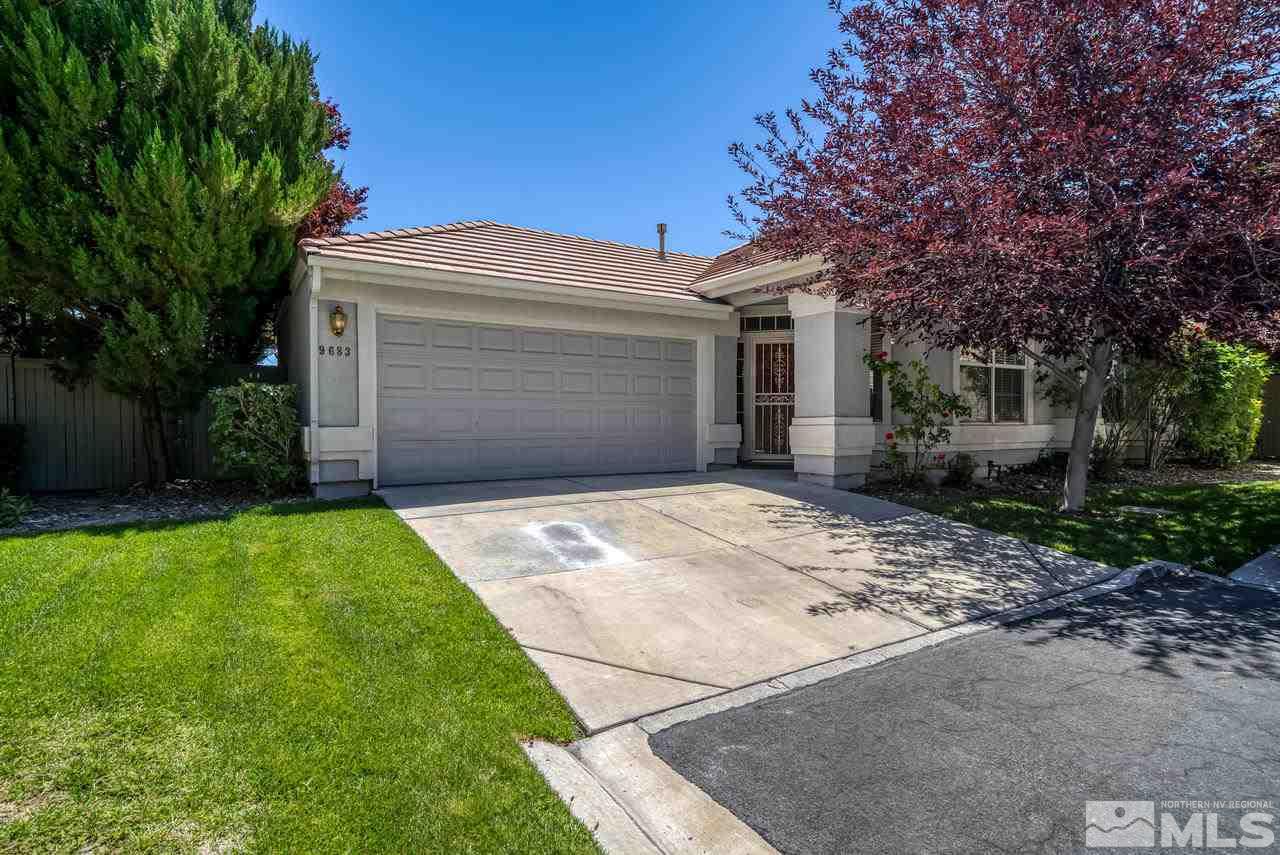 9683 Truckee Meadows Place Reno, NV 89521 - Photo 1 of 33 a front view of a house with a garden and trees