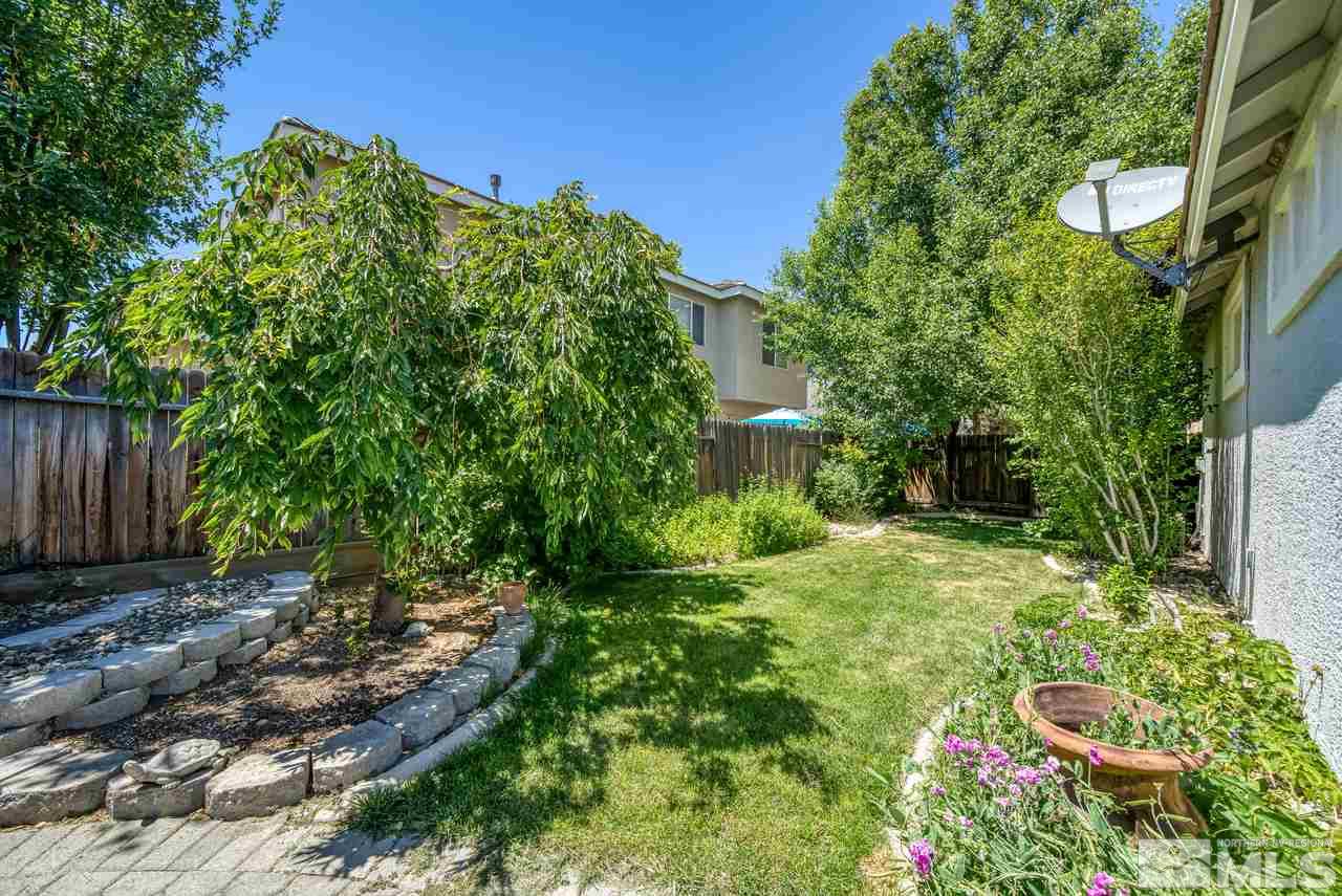 9683 Truckee Meadows Place Reno, NV 89521 - Photo 11 of 33 a backyard of a house with lots of green space