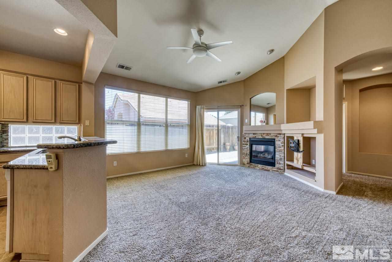 9683 Truckee Meadows Place Reno, NV 89521 - Photo 17 of 33 a view of an empty room with a fireplace and a window