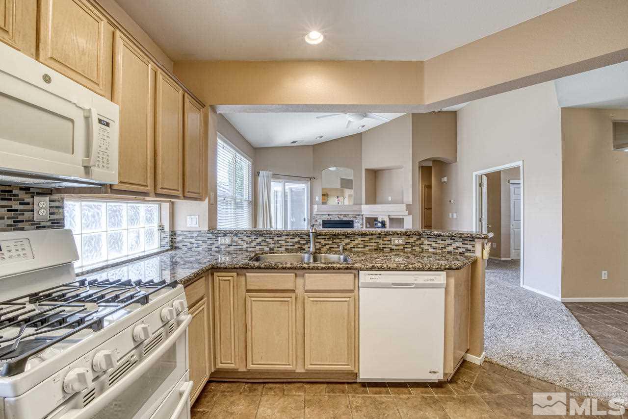 9683 Truckee Meadows Place Reno, NV 89521 - Photo 20 of 33 a kitchen with stainless steel appliances granite countertop a stove and a sink