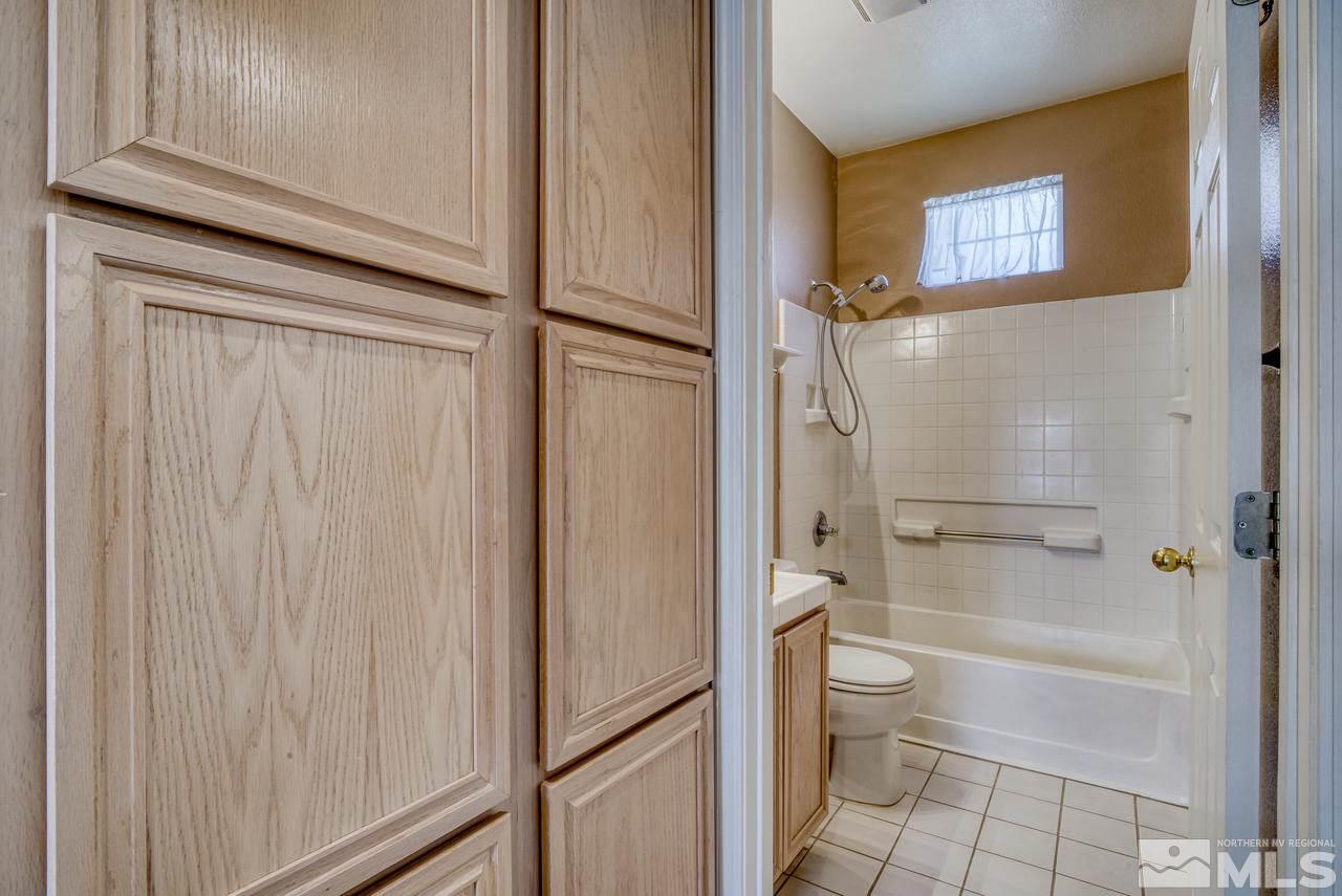 9683 Truckee Meadows Place Reno, NV 89521 - Photo 24 of 33 a bathroom with a granite countertop shower and a toilet