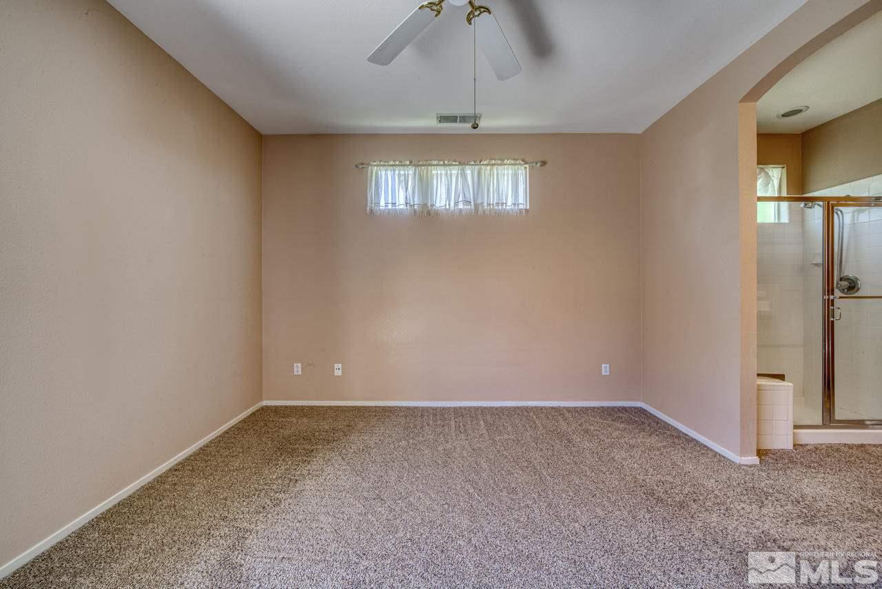 9683 Truckee Meadows Place Reno, NV 89521 - Photo 26 of 33 an empty room with windows and chandelier fan
