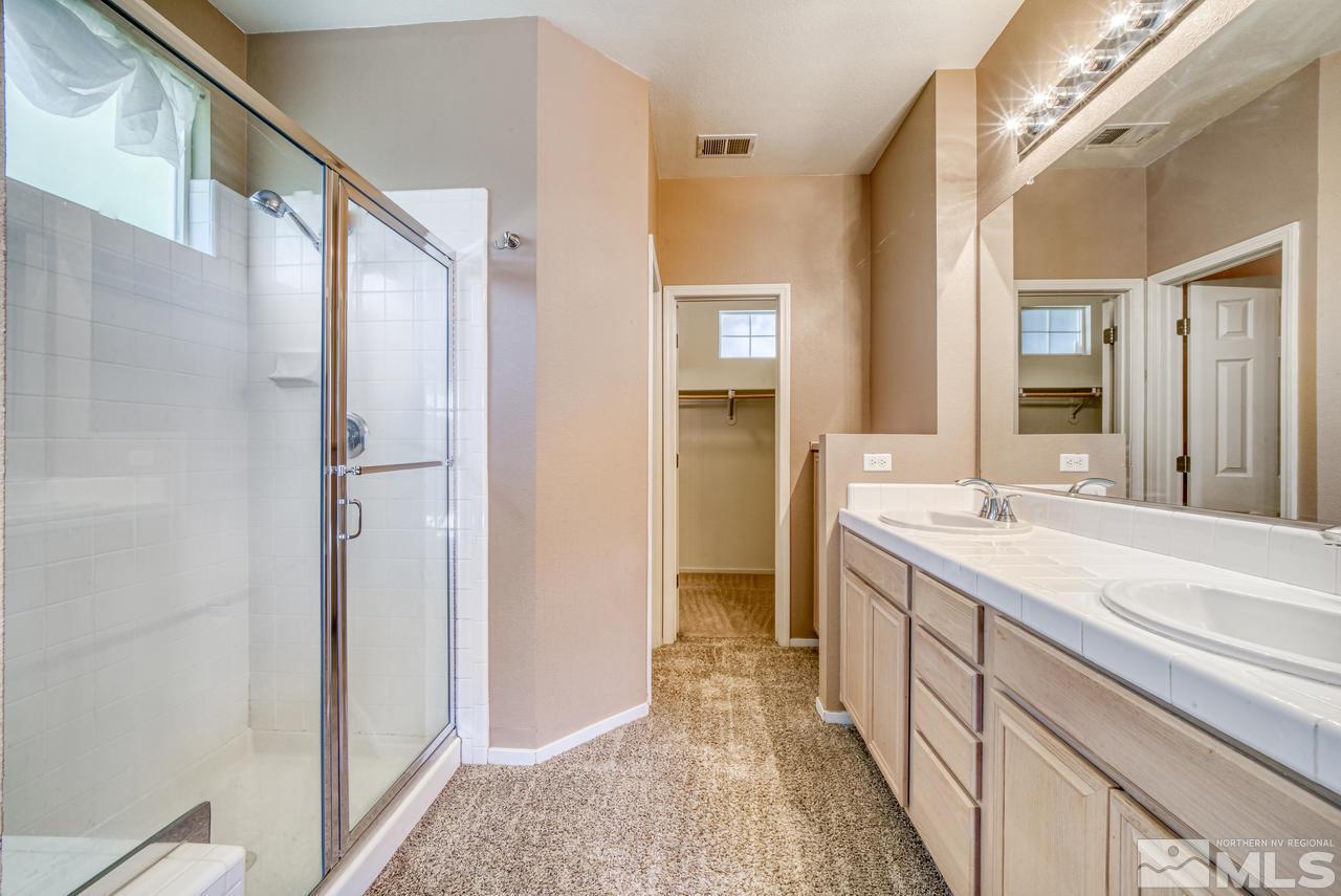 9683 Truckee Meadows Place Reno, NV 89521 - Photo 28 of 33 a bathroom with a double vanity sink mirror and shower