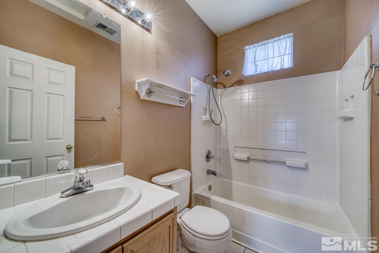 9683 Truckee Meadows Place Reno, NV 89521 - Photo 8 of 33 a bathroom with a sink toilet and shower