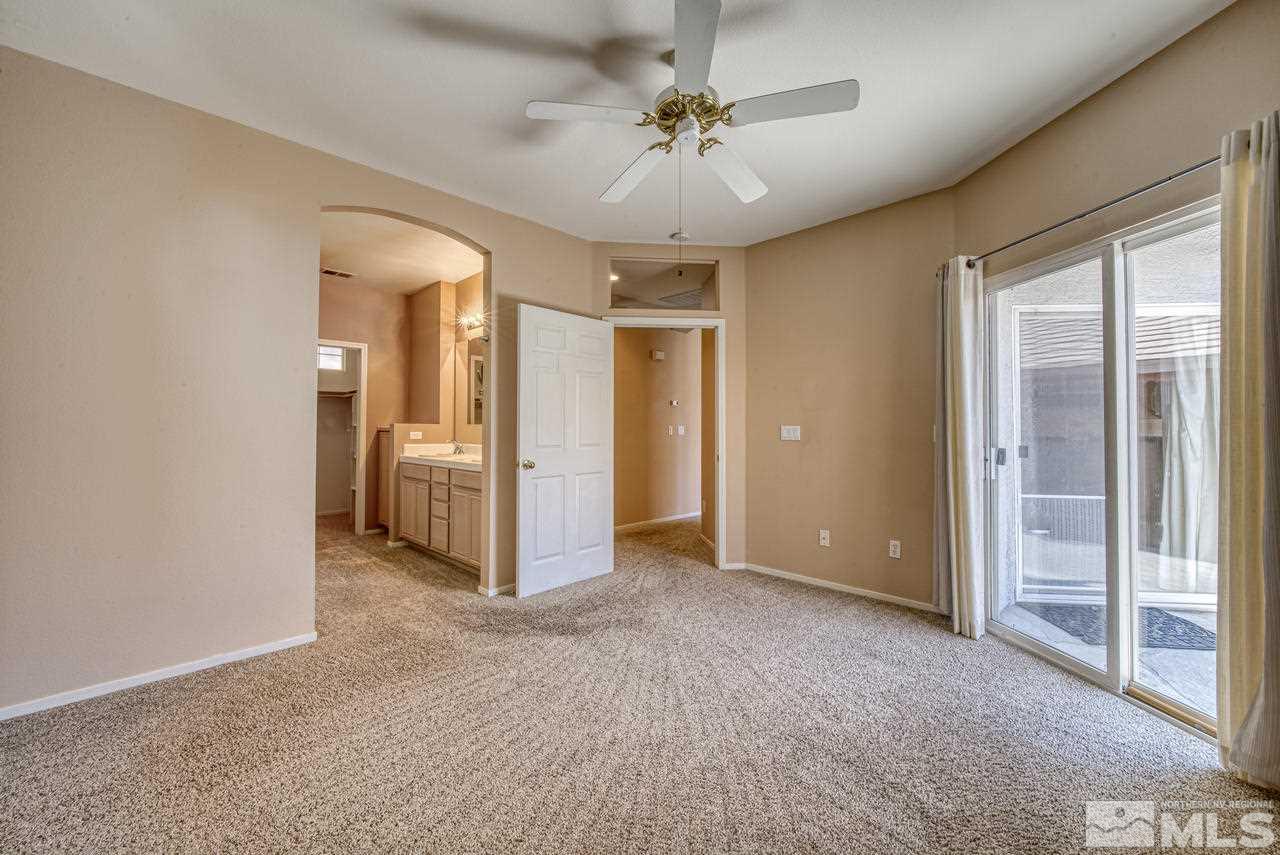 9683 Truckee Meadows Place Reno, NV 89521 - Photo 9 of 33 a view of a livingroom with a chandelier fan and windows
