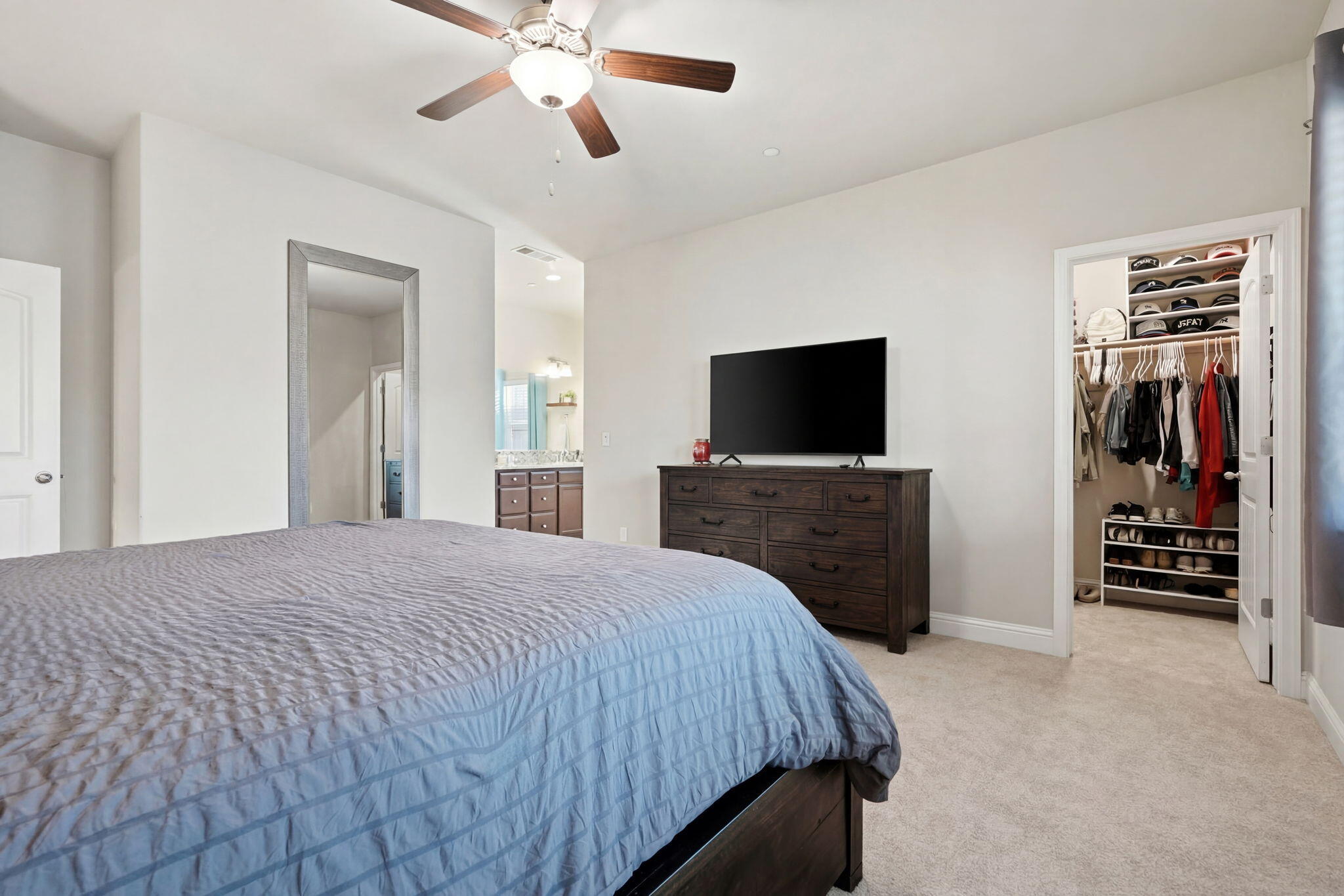 756 Strada Street Lemoore, CA 93245 - Photo 32 of 53 a bedroom with a bed and a flat tv screen on dresser
