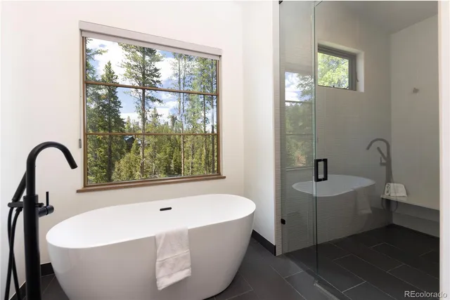 a white bath tub sitting next to a window