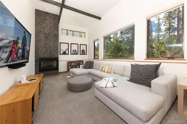 a living room with furniture fireplace and window
