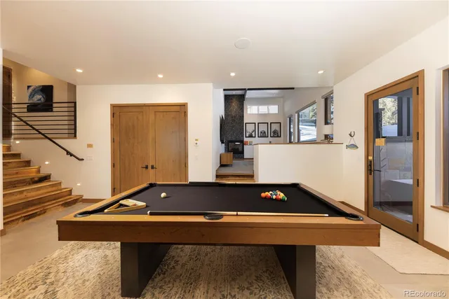 a room with table chairs and stairs