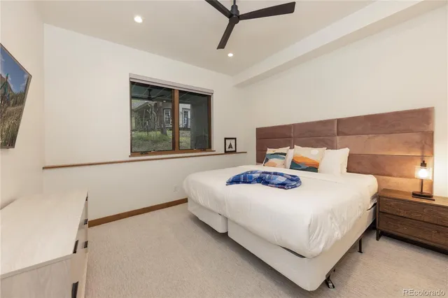 a bedroom with a bed a dresser and a window