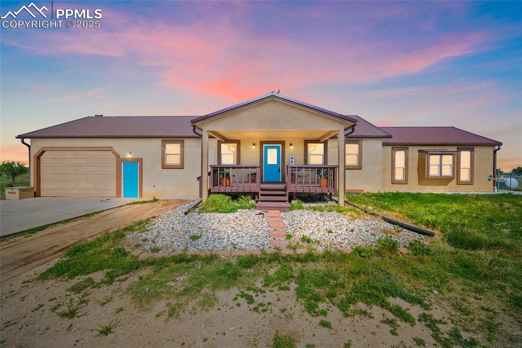 a front view of a house with a garden and patio