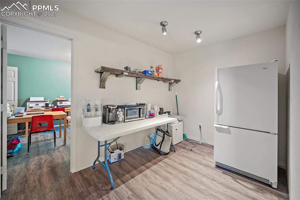 5335 Whittemore Road Rush, CO 80833 - Photo 19 of 49 a view of a workspace with furniture and wooden floor