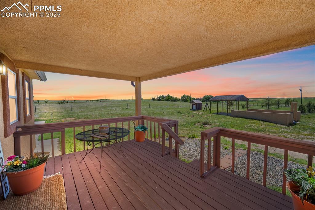 5335 Whittemore Road Rush, CO 80833 - Photo 3 of 49 a view of a balcony with couch and wooden floor