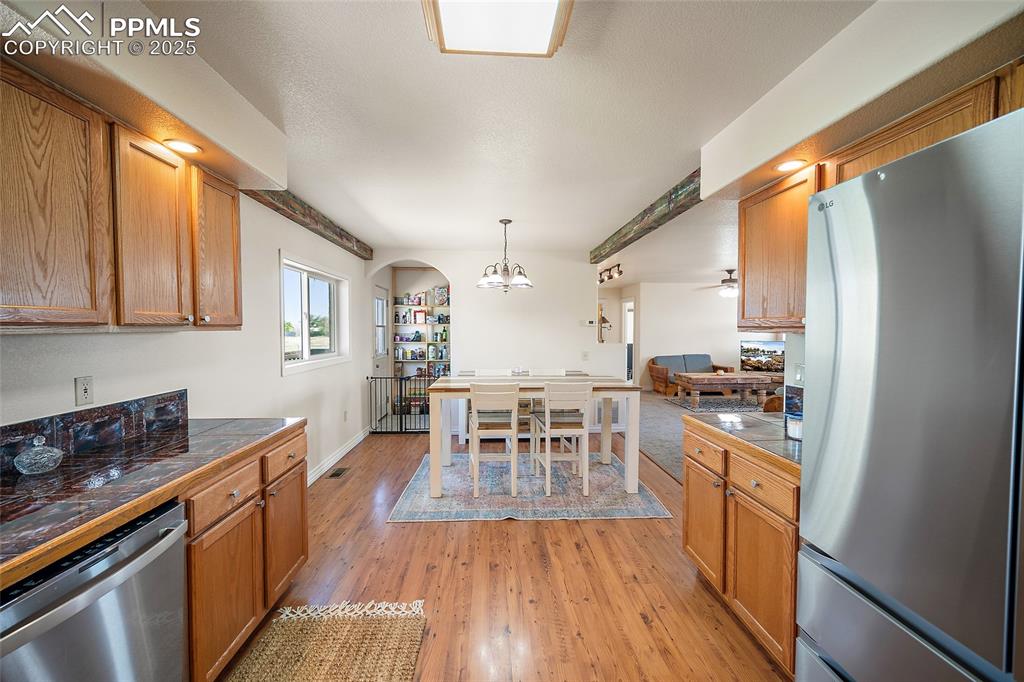 5335 Whittemore Road Rush, CO 80833 - Photo 8 of 49 a kitchen with wooden floors and wooden cabinets