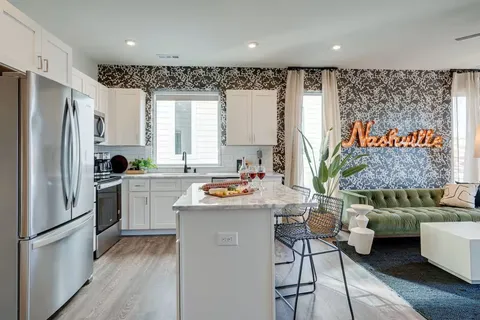 a kitchen with stainless steel appliances a refrigerator a sink and a stove top oven