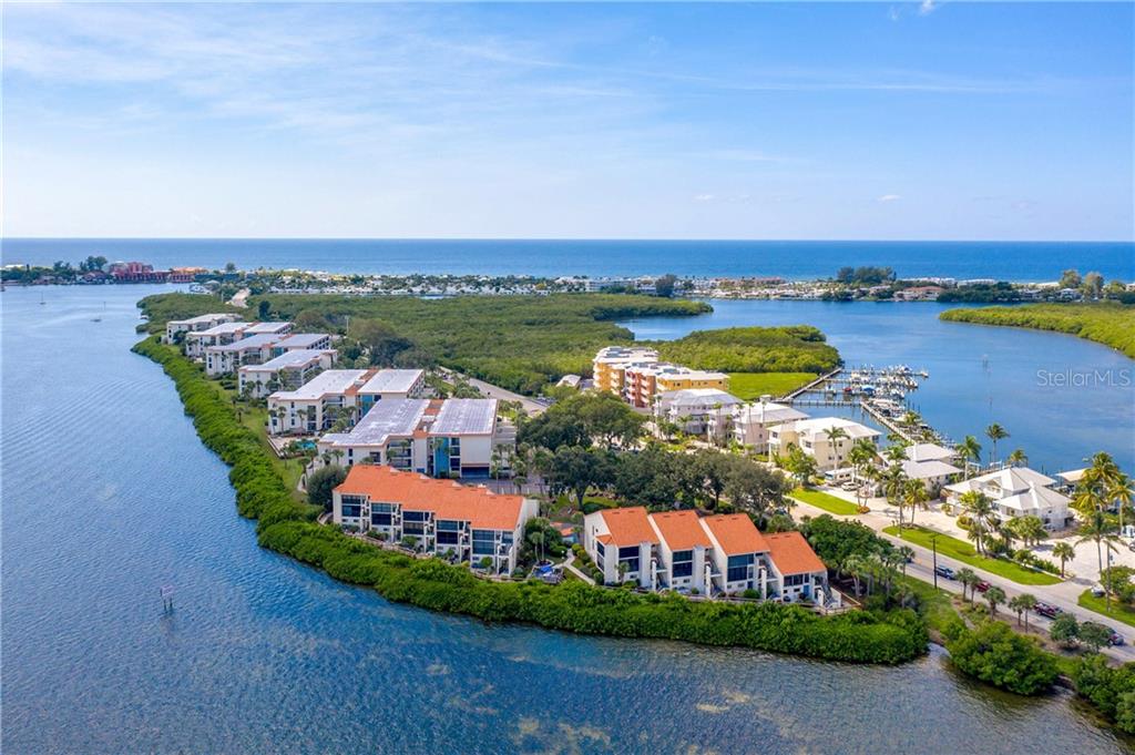 AERIAL VIEW OF SANDPIPER KEY CONDOMINIUMS.  THEY ARE THE BUILDINGS ALONG THE BAY ON THE LEFT SIDE OF BEACH ROAD.