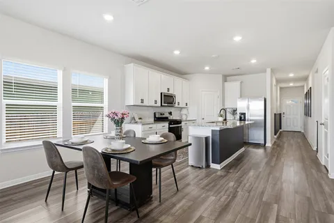 a view of a dining room with furniture and wooden floor