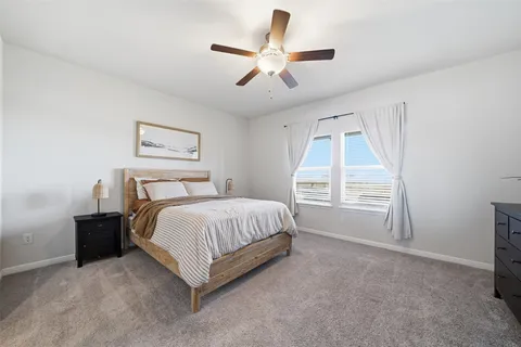 a spacious bedroom with a bed and a large window