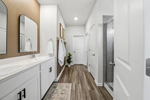 a spacious bathroom with a double vanity sink and a mirror