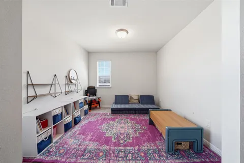 a living room with furniture and a rug