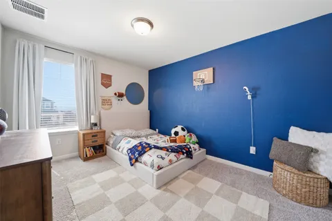 a bedroom with a bed and a couch