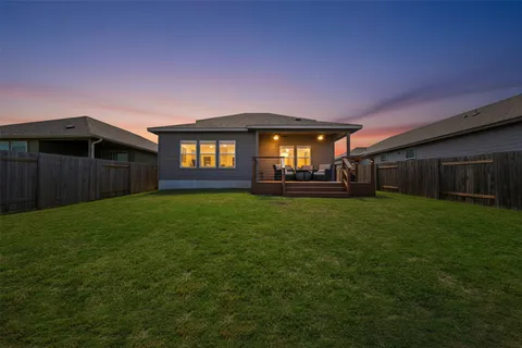 a front view of a house with a garden and yard