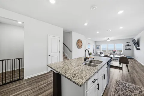 a kitchen with kitchen island granite countertop a table and chairs in it