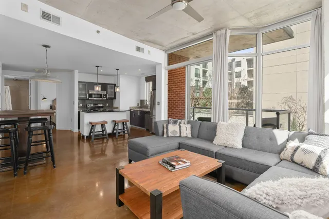 a living room with furniture and a large window