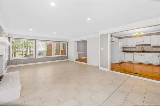 a large white kitchen with a large window