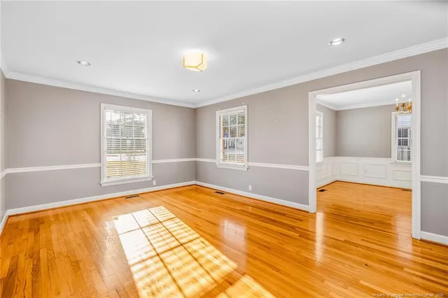 a view of an empty room with window and a bathroom
