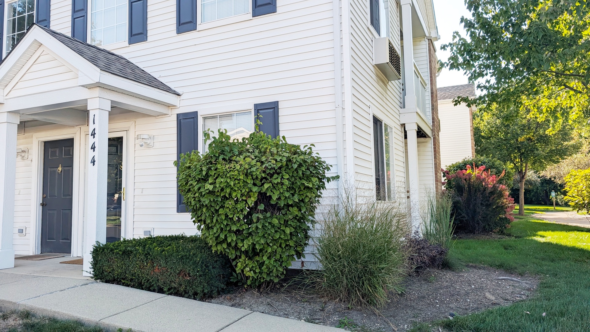 1444 McClure Road, Unit 1444 Aurora, IL 60505 - Photo 1 of 8 a front view of a house with garden