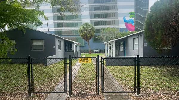 a front view of house with sign board