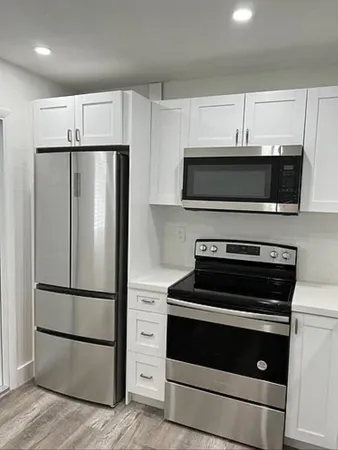 a kitchen with a refrigerator stove and microwave