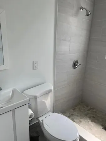 a white toilet sitting next to a bathroom sink