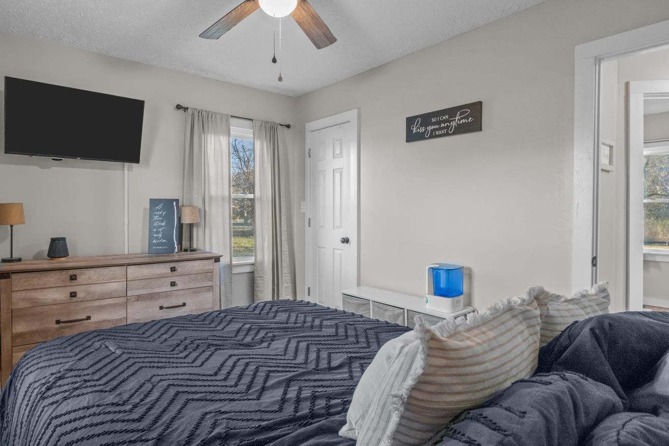 206 Joe Street Waverly, TN 37185 - Photo 11 of 28 a bedroom with a bed and a flat screen tv