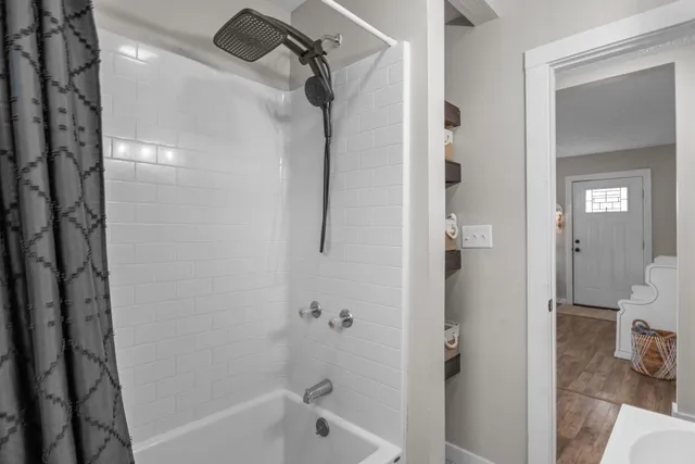 a bathroom with a bathtub and a shower