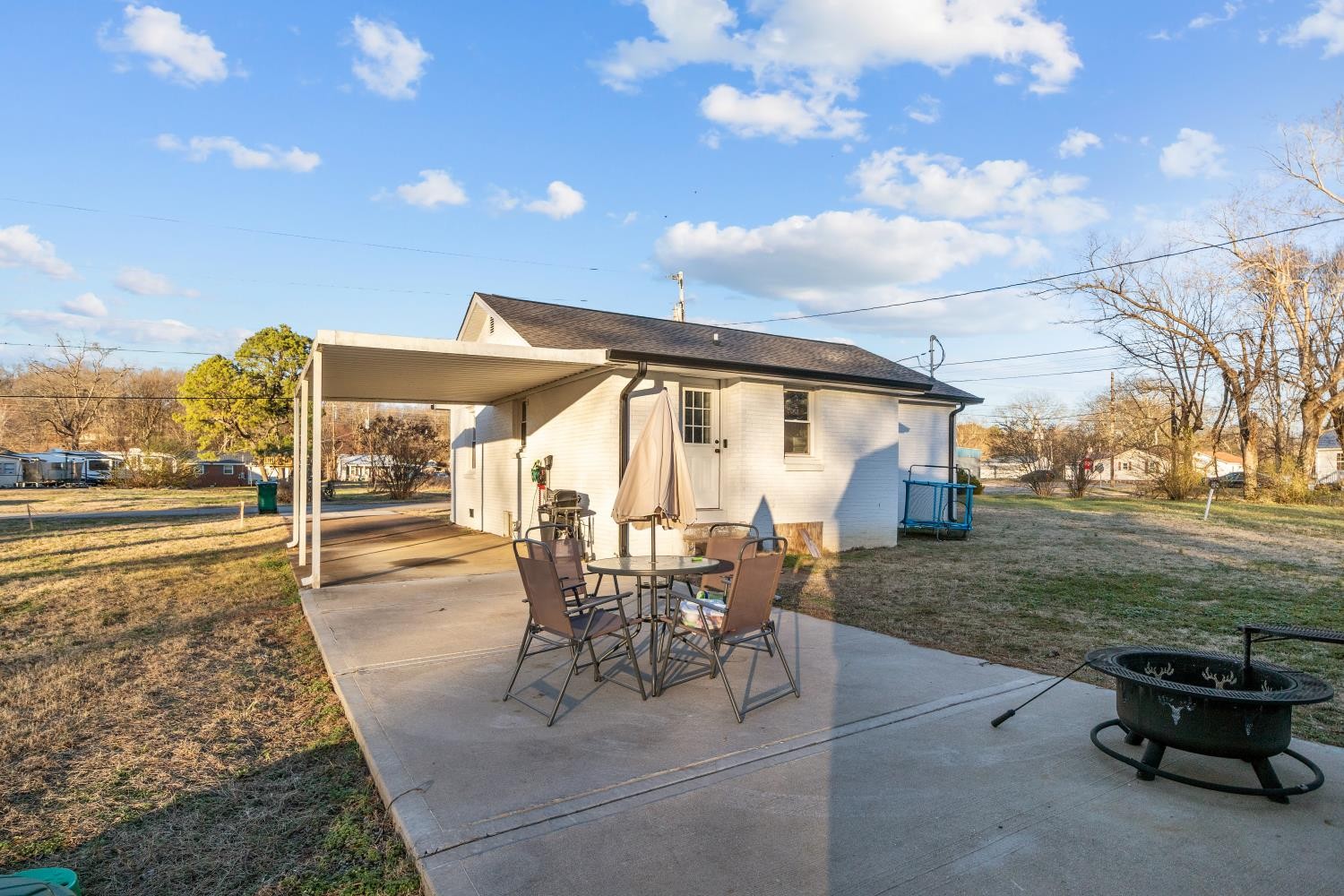 206 Joe Street Waverly, TN 37185 - Photo 20 of 28 a view of a patio with table and chairs with wooden floor and fence