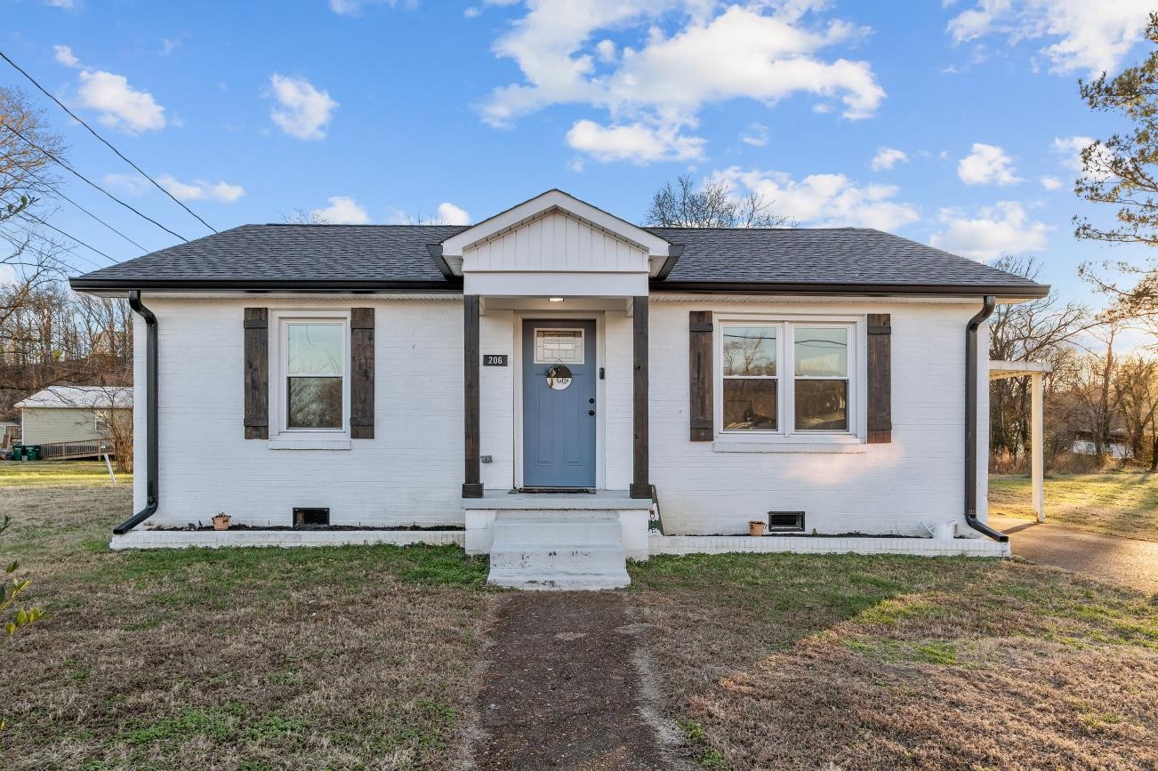 206 Joe Street Waverly, TN 37185 - Photo 2 of 28 a front view of a house with garden