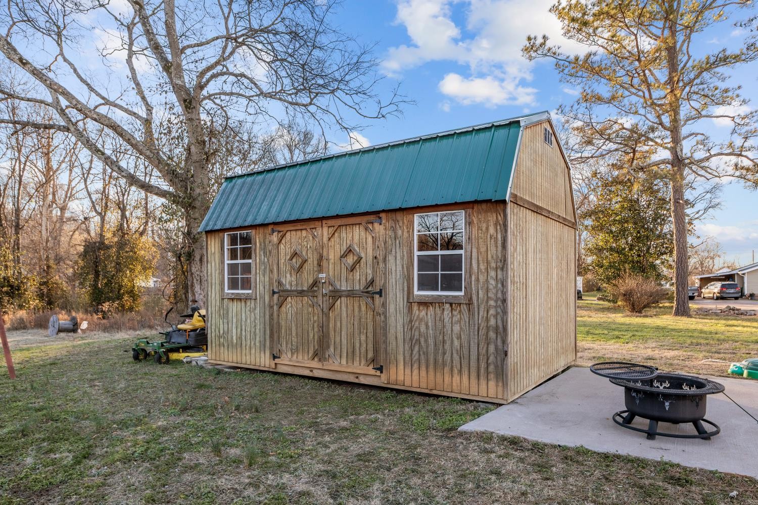206 Joe Street Waverly, TN 37185 - Photo 24 of 28 a backyard of a house with wooden fence and a large tree