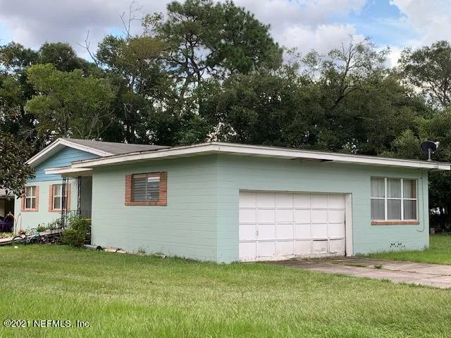 a house that has a tree in front of it