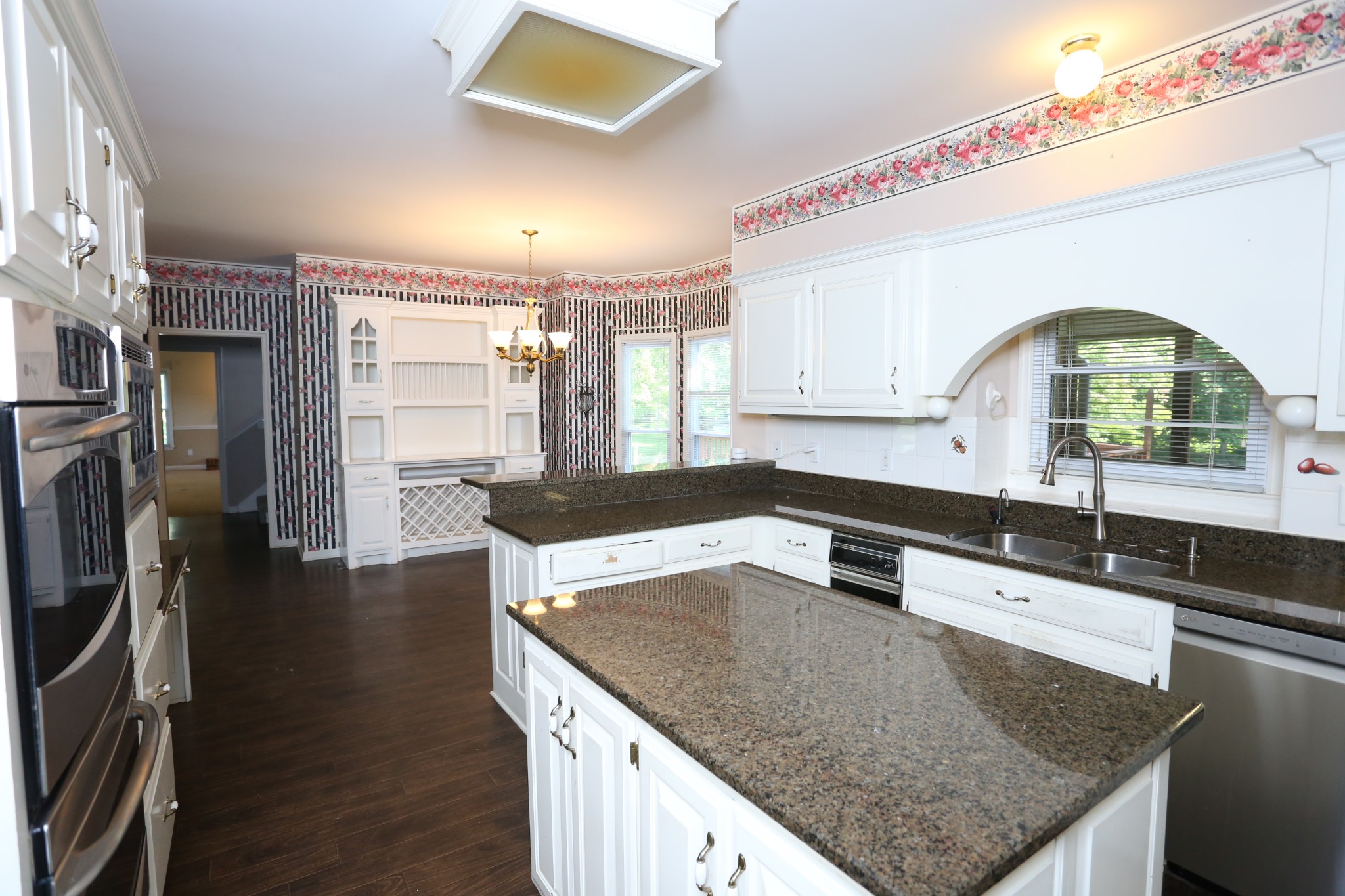 4026 Windland Drive Springfield, TN 37172 - Photo 17 of 48 a kitchen with stainless steel appliances granite countertop a sink a stove and a wooden floors