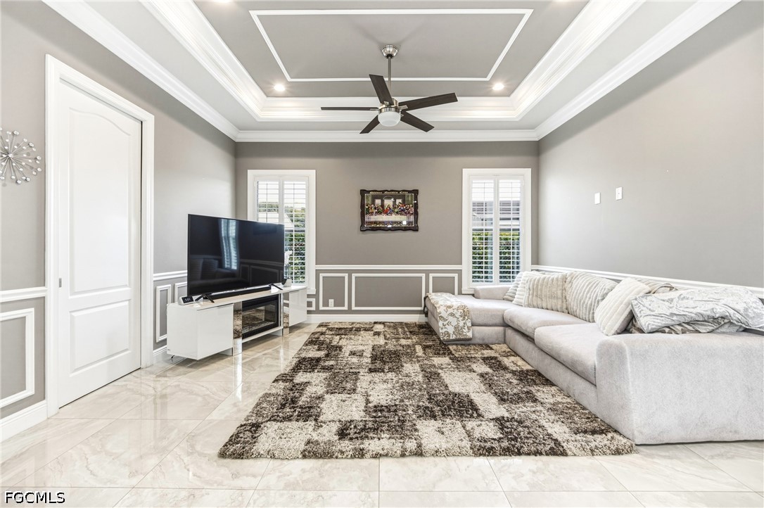 1700 43rd Terrace Southwest Naples, FL 34116 - Photo 15 of 38 a living room with furniture and a flat screen tv