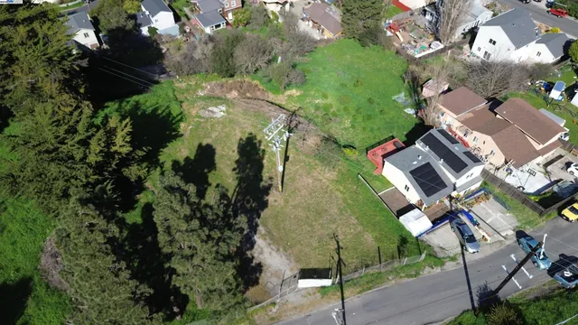 an aerial view of residential house with outdoor space and trees all around