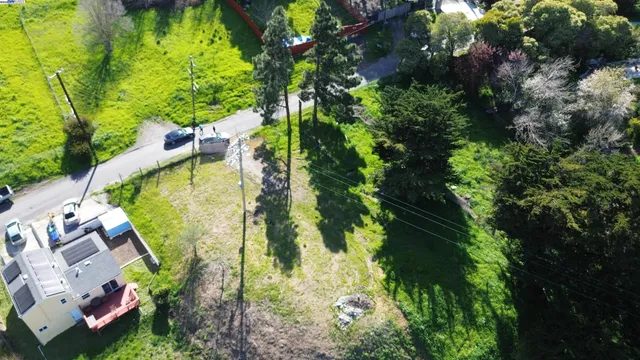 an aerial view of a house with swimming pool and garden
