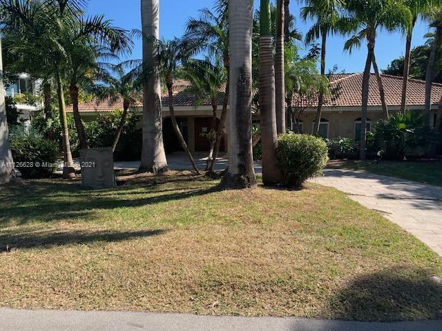 323 Caribbean Road Key Biscayne, FL 33149 - Photo 1 of 20 a view of a backyard with a patio
