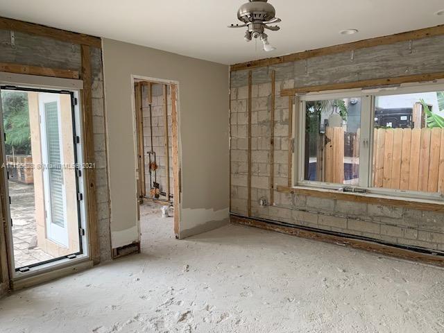 323 Caribbean Road Key Biscayne, FL 33149 - Photo 11 of 20 wooden floor and window in an empty room