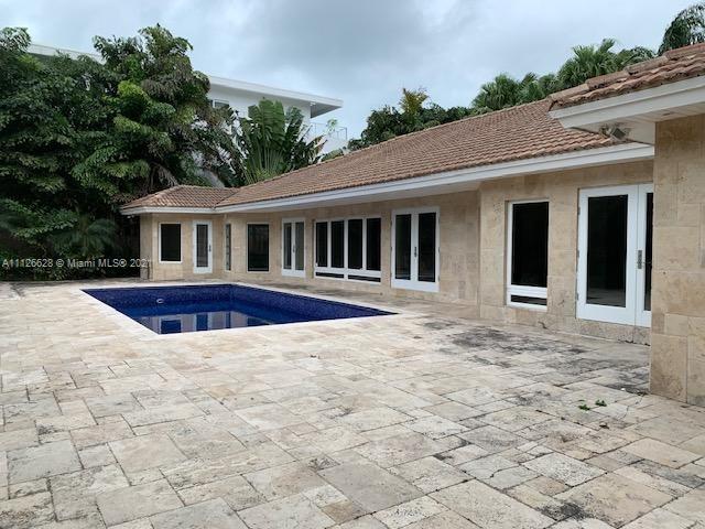 323 Caribbean Road Key Biscayne, FL 33149 - Photo 19 of 20 a view of a house with a small yard