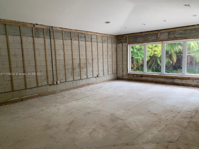 323 Caribbean Road Key Biscayne, FL 33149 - Photo 4 of 20 an empty room with large windows and outdoor space