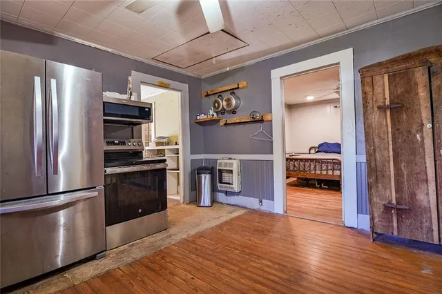 a kitchen with stainless steel appliances granite countertop a refrigerator and a stove top oven