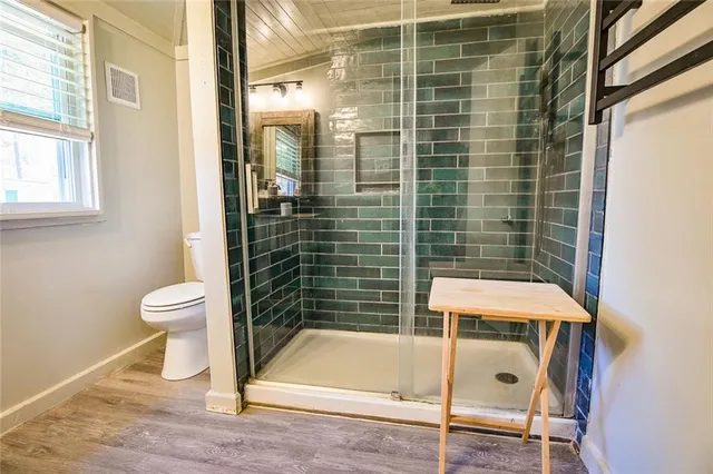 a bathroom with a toilet and a shower